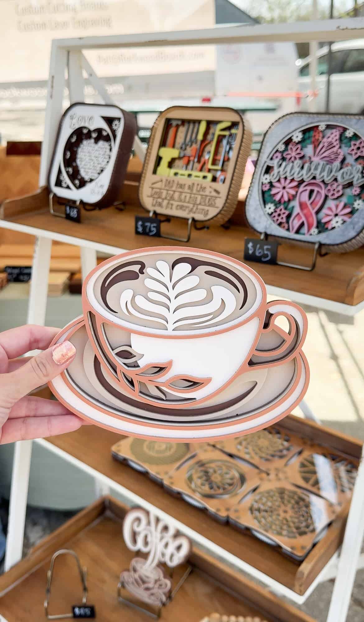 A handcrafted coffee-cup decor piece is displayed at the Tomball Farmers Market.