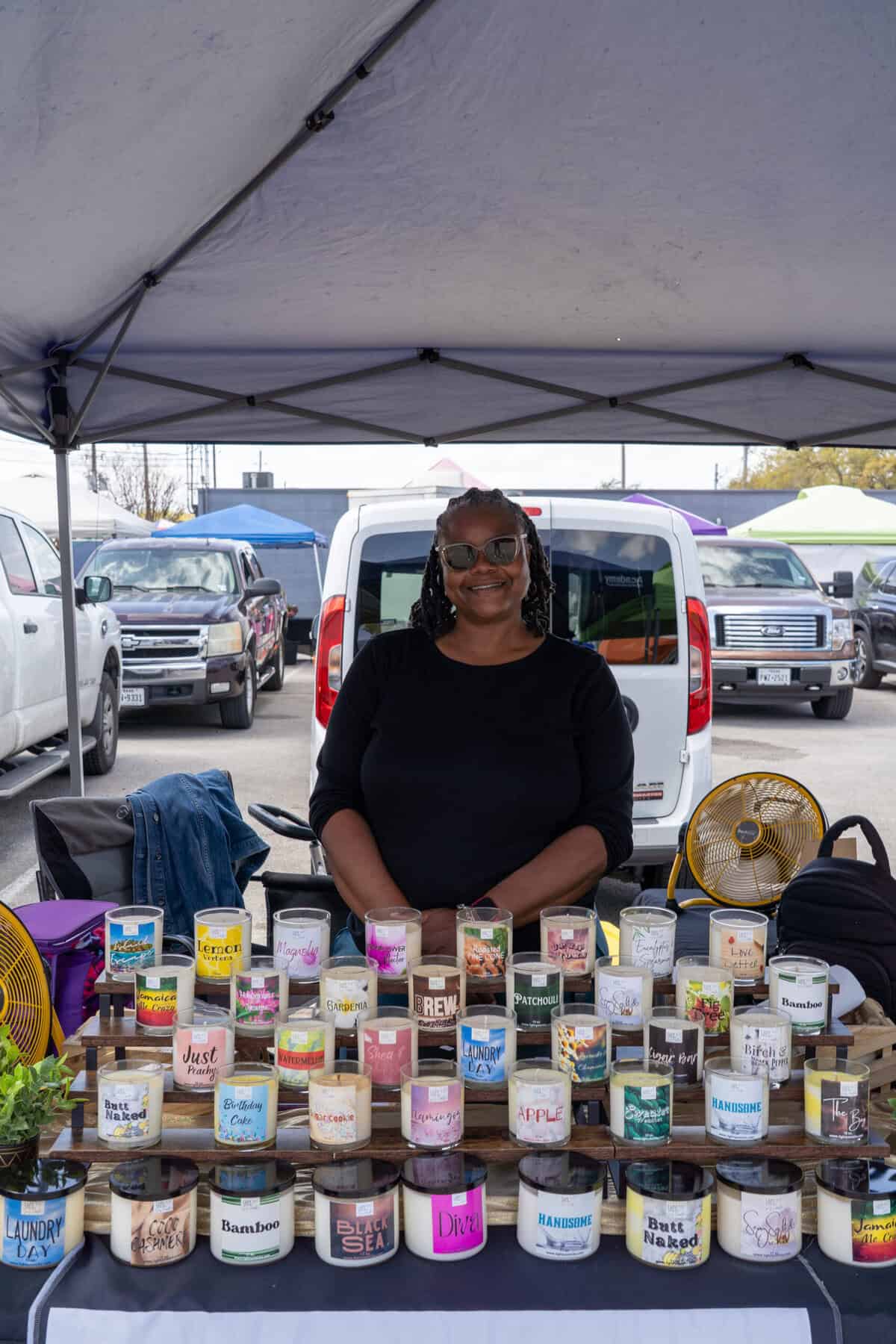 The bustling Tomball Farmers Market with colorful vendor tents and shoppers