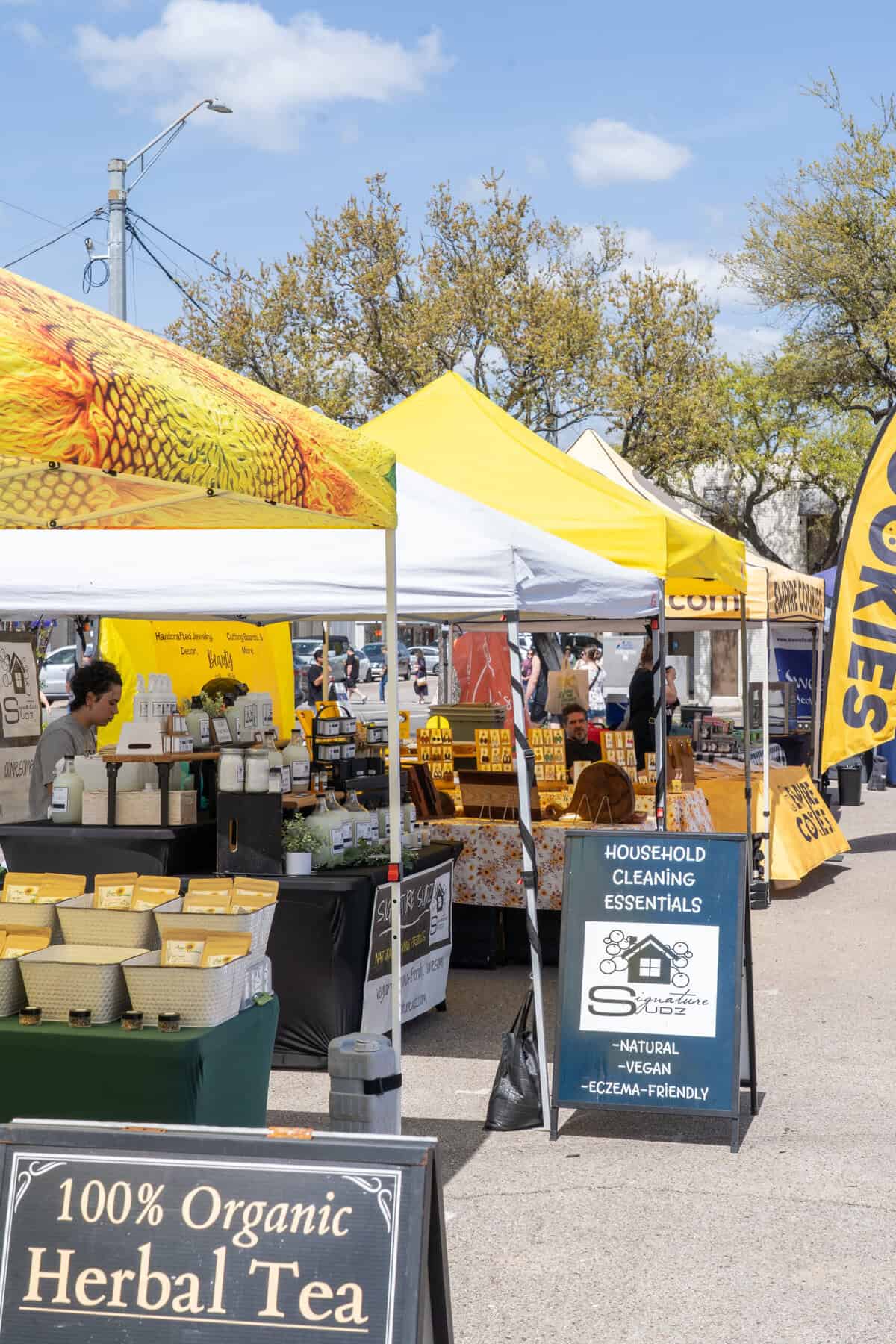 Vendor tents line the Tomball Farmers Market on a sunny Saturday.