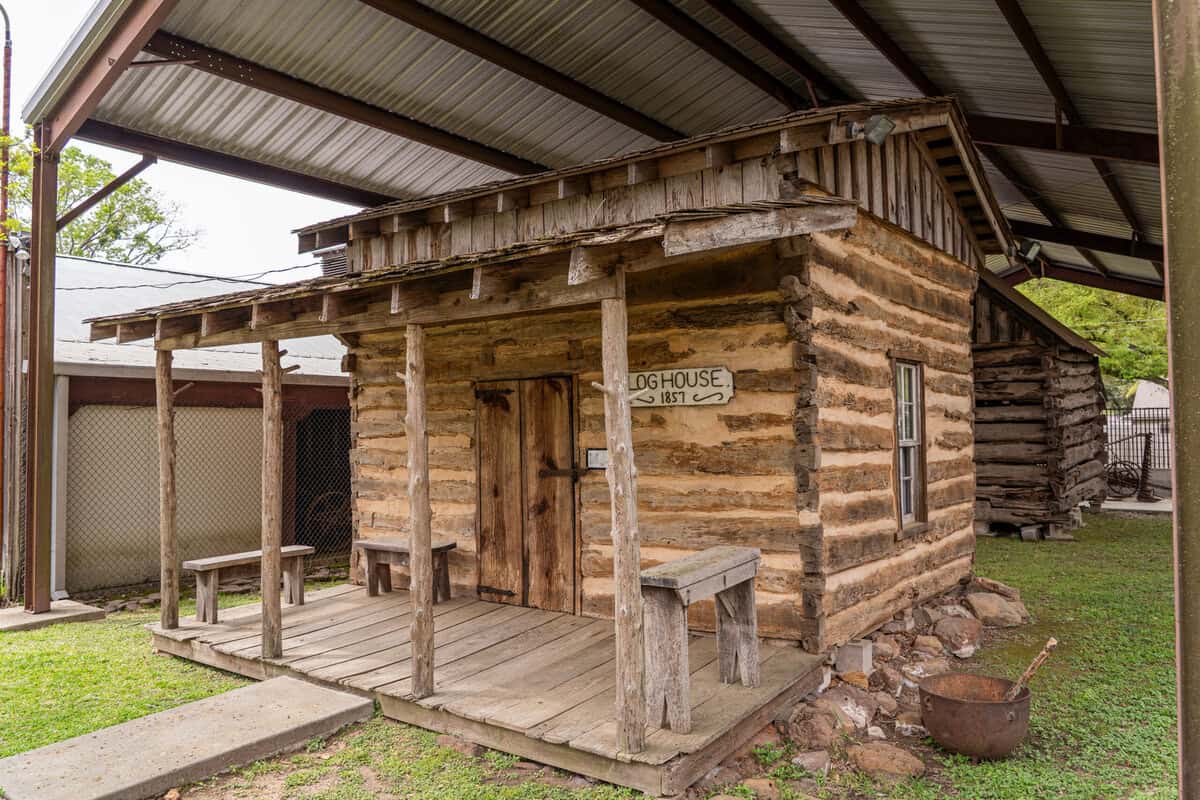 The exterior of a log cabin at the Tomball Museum Center