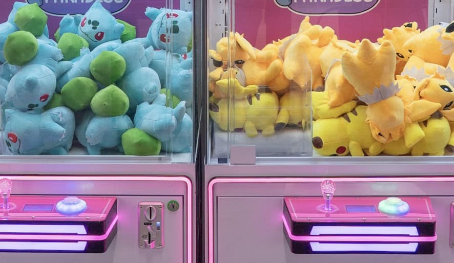 Claw machines filled with plush prizes at Claw City in Tomball