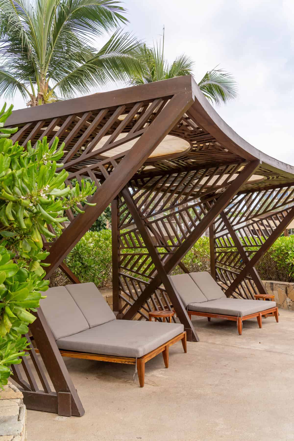 Shaded lounge beds by the pool at Conrad Punta de Mita.
