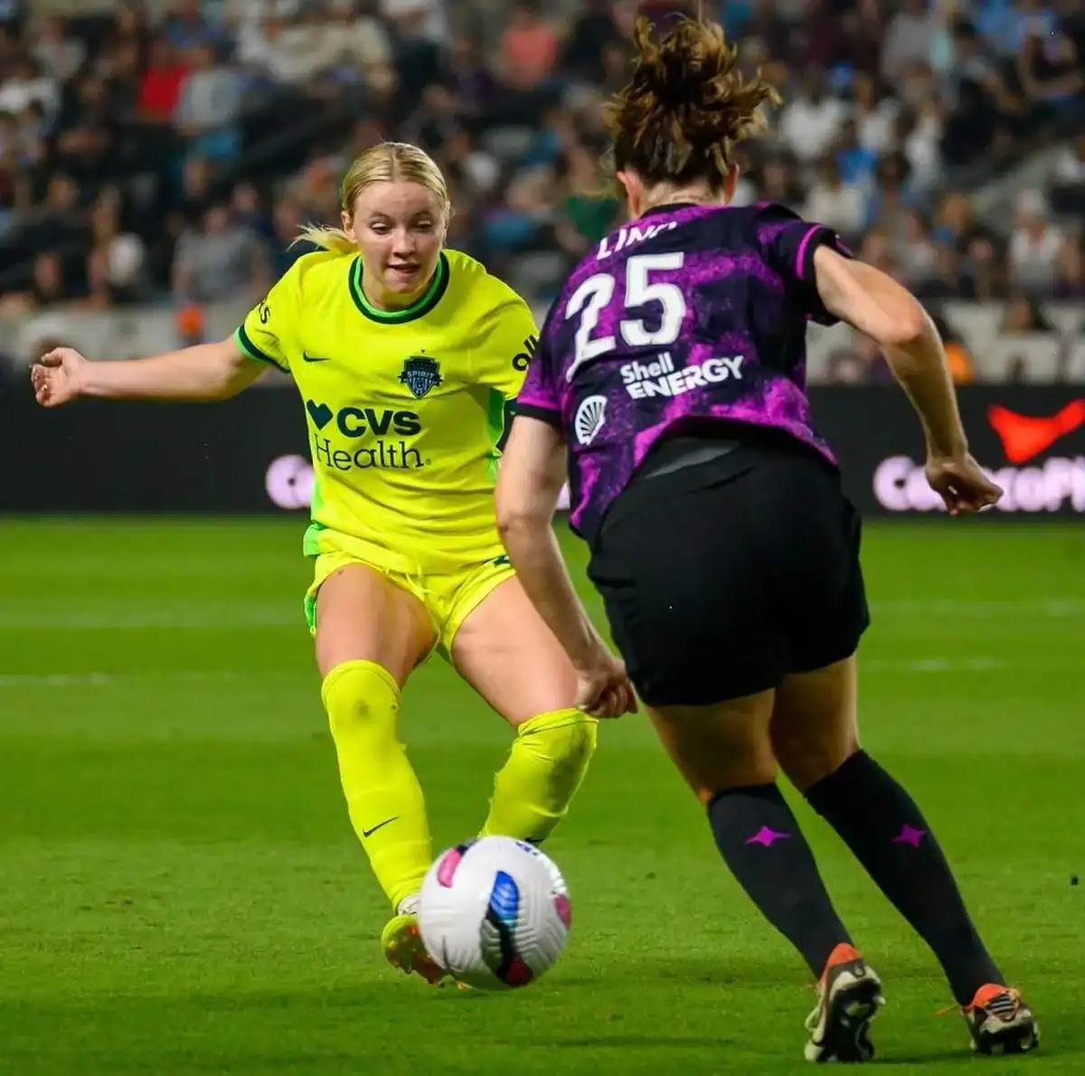 Houston Dash player defending against Washington Spirit during the 2025 NWSL season opener at Shell Energy Stadium