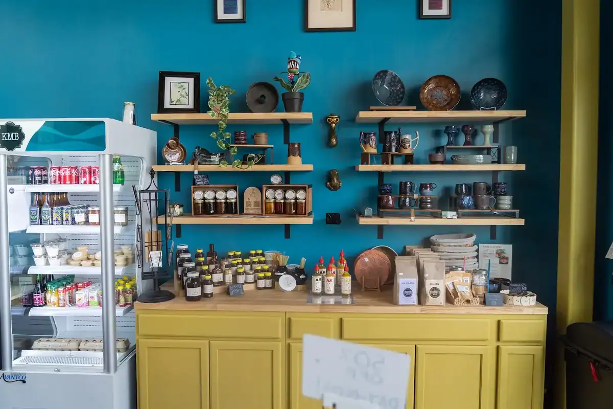 Shelf featuring products from local businesses at Knead Me Bakery