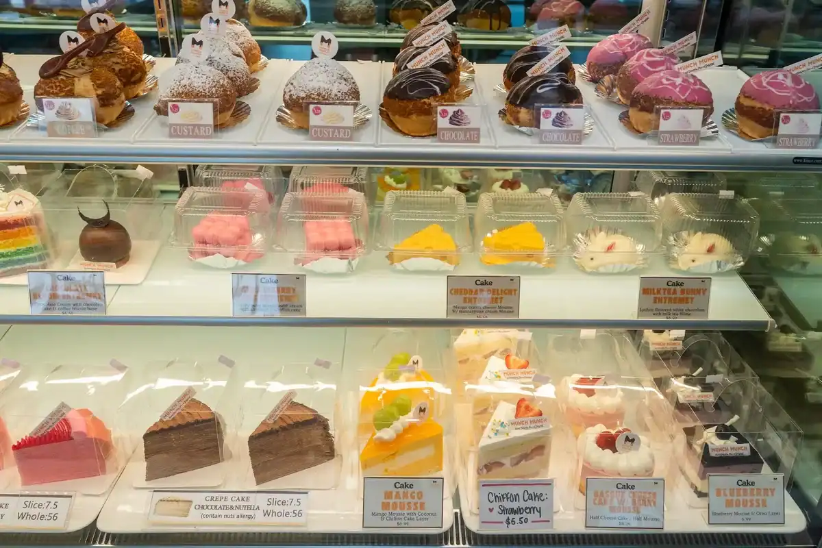 Colorful dessert display case at MunchMunch Mochi Donut and Bakery