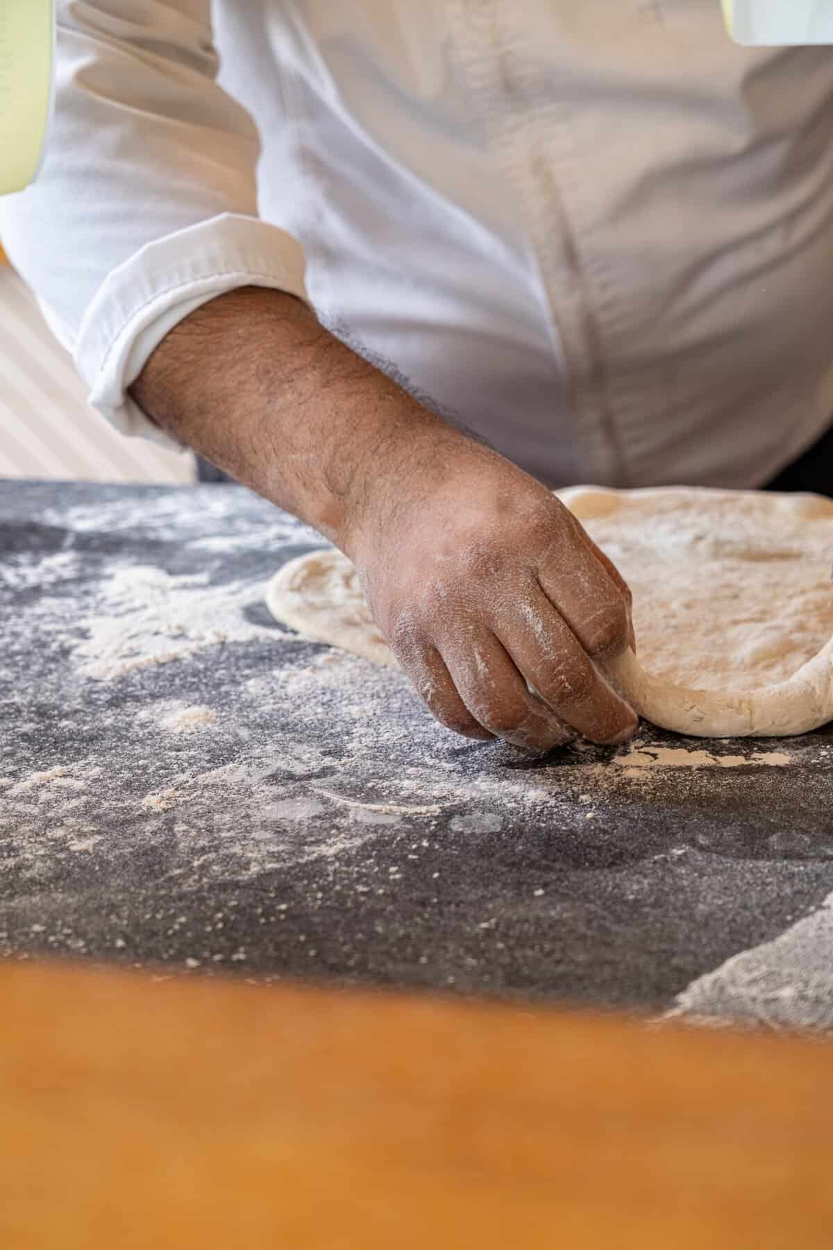 Fresh pizza dough being prepared at Paleta Poolside Grill at Conrad Punta de Mita.