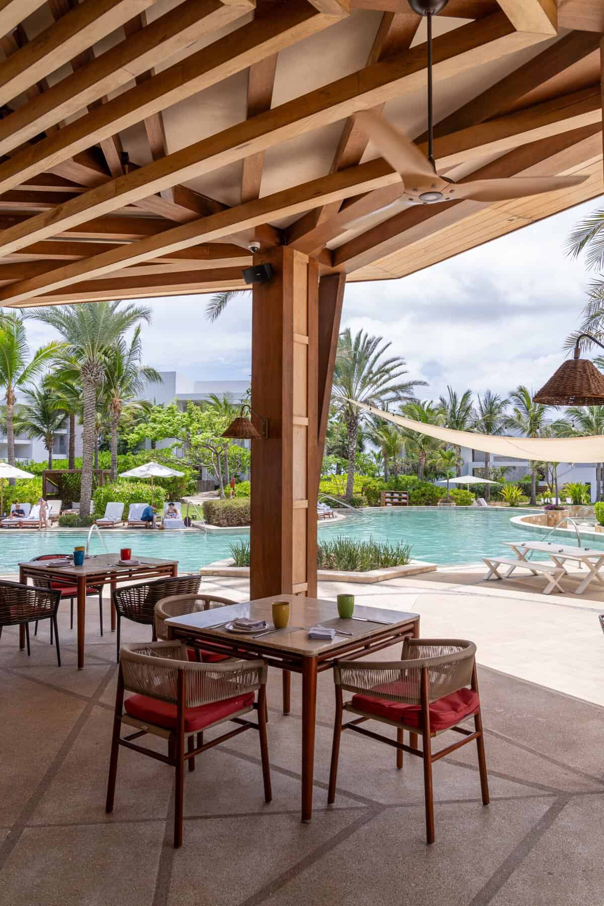 Poolside tables and family pool view at Paleta Poolside Grill at Conrad Punta de Mita.