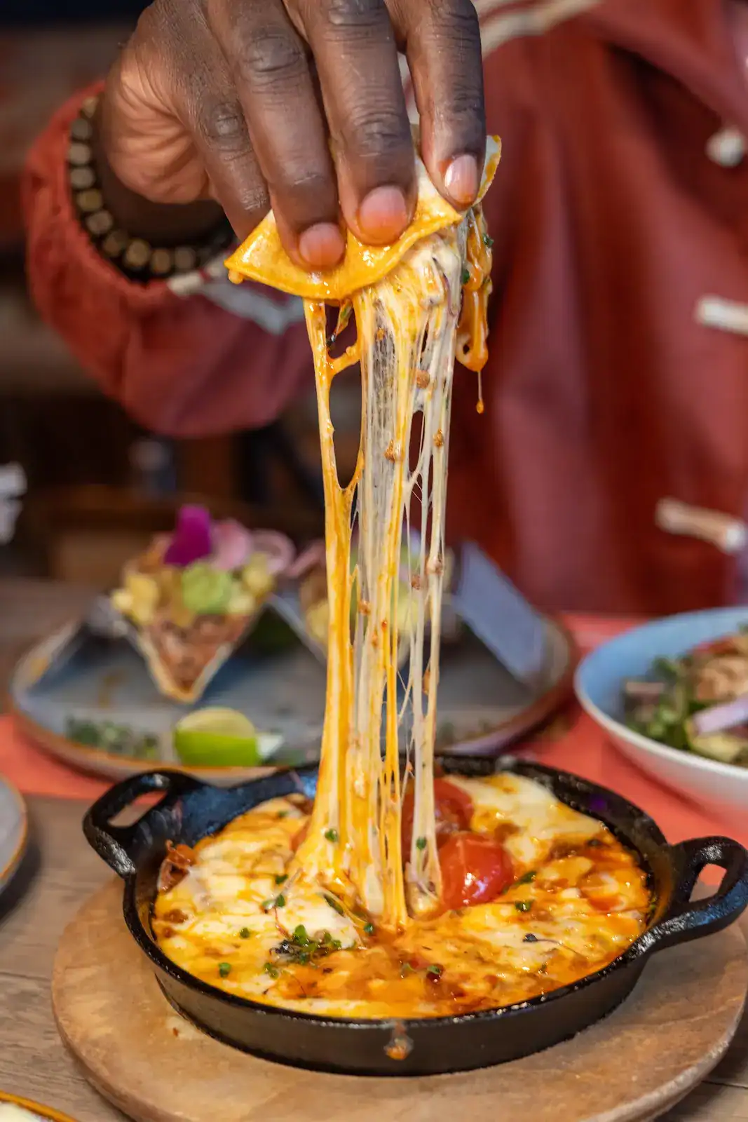 Queso fundido cheese pull at Sin Yolanda in Shenandoah