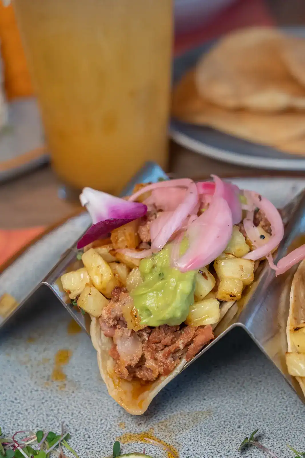 Taco topped with pickled red onions at Sin Yolanda