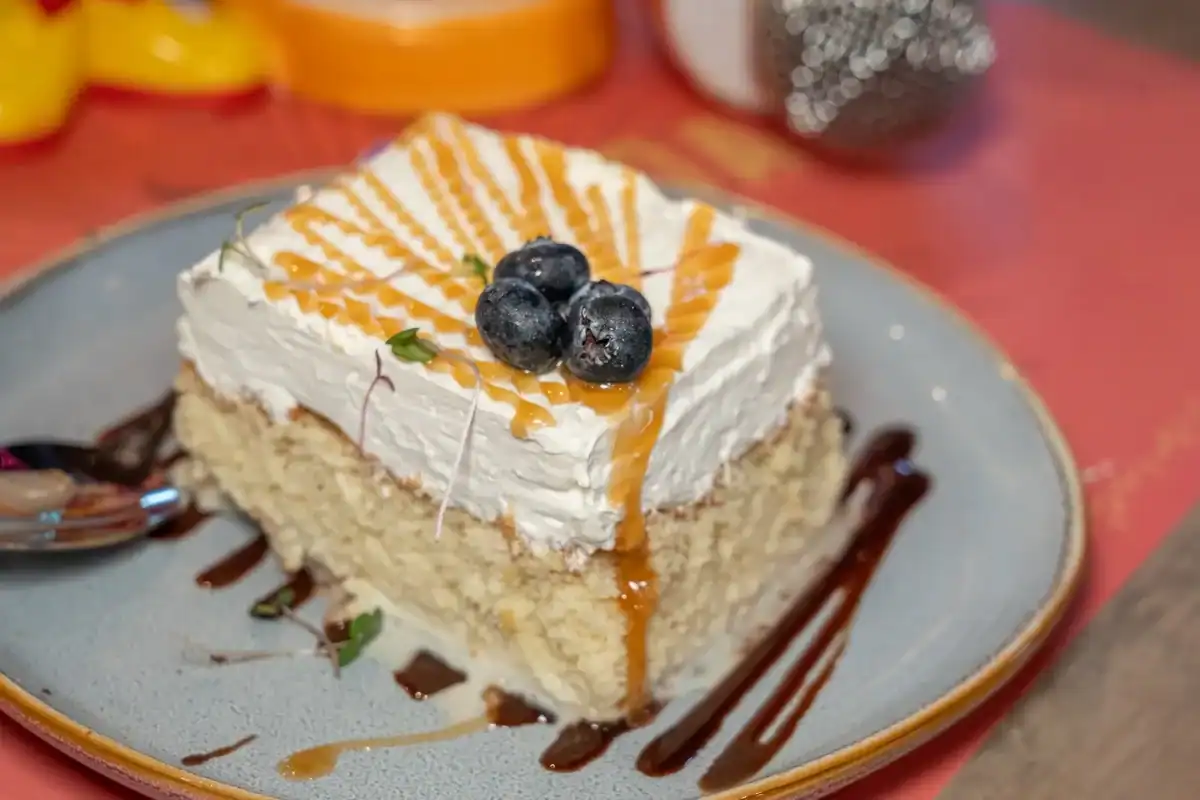 Tres leches-style dessert with caramel and blueberries at Sin Yolanda