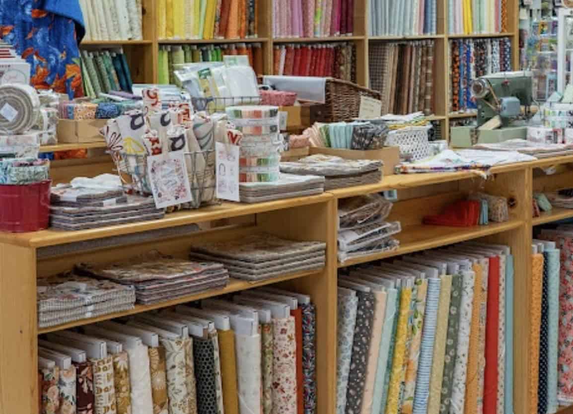 Fabric shelves and quilting supplies at The Quilty Shop in Tomball