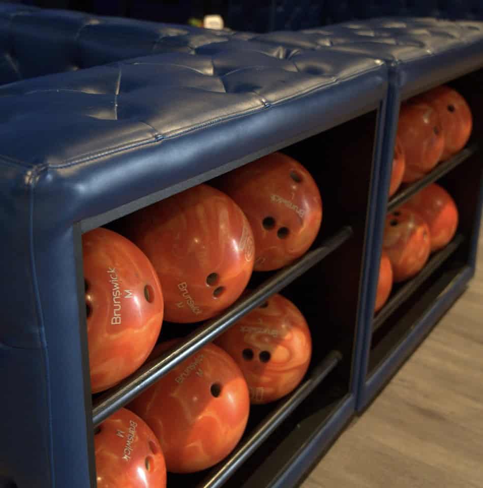 Bowling balls and lounge seating at Tomball Bowl
